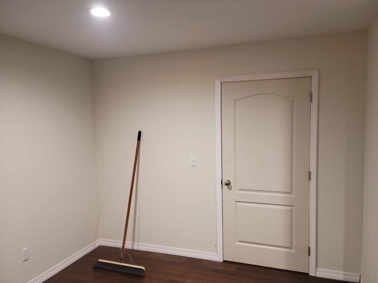 White room with Broom and closed door